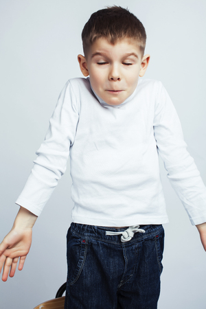 little cute boy on white background gesture smiling close up, lifestyle people conceptの写真素材
