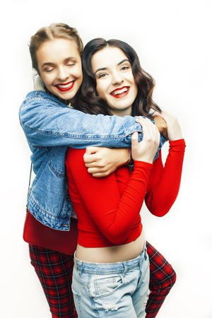 two best friends teenage girls together having fun, posing emotional on white background, besties happy smiling, making selfie, lifestyle people conceptの写真素材