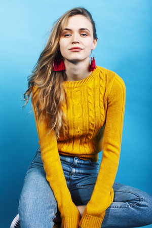 young pretty teenage modern hipster girl posing emotional happy on blue background, lifestyle people conceptの写真素材