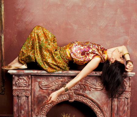 portrait of beauty sensual young woman in oriental style luxury room, lifestyle people closeupの写真素材