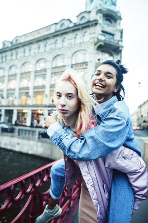 Two teenage girls infront of university building smiling, having fun, lifestyle real people concept close upの写真素材