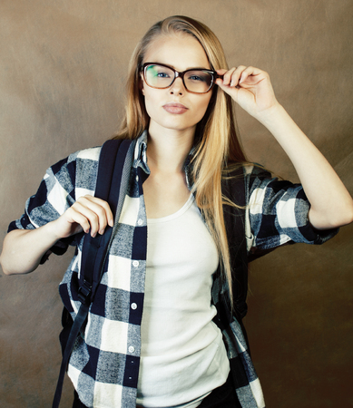 young pretty girl teenager in glasses making selfie at school, student with backpack, lifestyle and people conceptの写真素材