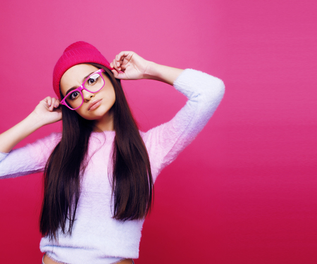young cute girl on pink background smiling adorable emotional posing, lifestyle people conceptの写真素材