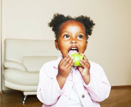ittle cute african american girl playing at home, pretty adorable princess in interior happy smiling, lifestyle real people conceptの写真素材