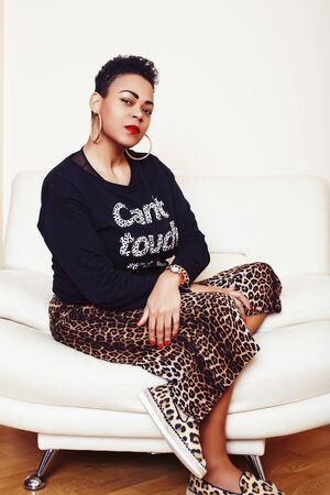 pretty stylish african american big mama woman well dressed. swag relax at home, leopard print on clothers. fashion look sunglassesの写真素材
