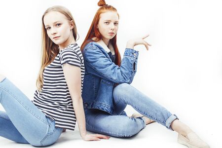 two best friends teenage girls together having fun, posing emotional on white background, besties happy smiling, making selfie, lifestyle people conceptの写真素材