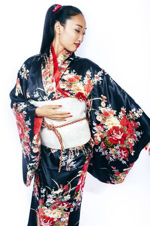 young pretty real geisha in kimono with sakura and decoration on white background isolatedの写真素材