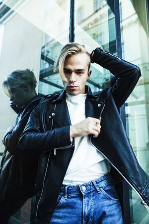 young modern hipster guy at new building university blond fashion handsome boy, lifestyle people...