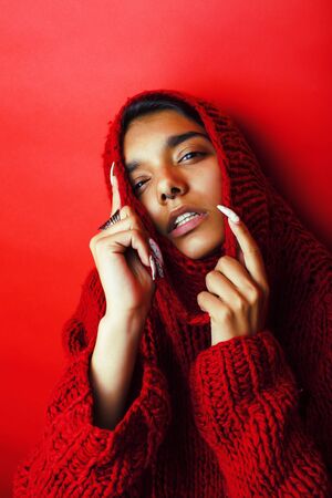 young pretty indian girl in red sweater posing emotional, fashion hipster teenage, lifestyle people concept close upの写真素材