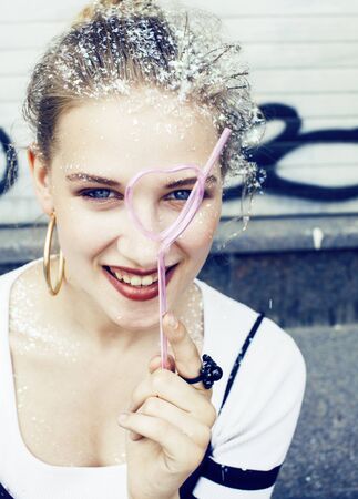young pretty party girl smiling covered with glitter tinsel, fashion lifestyle people conceptの写真素材