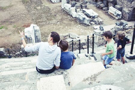 mother with little sons on vacation visiting ancient colosseum, summer tourism, lifestyle people conceptの写真素材
