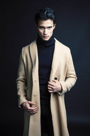 handsome asian fashion looking man posing in studio on black background, lifestyle modern people concept close upの写真素材