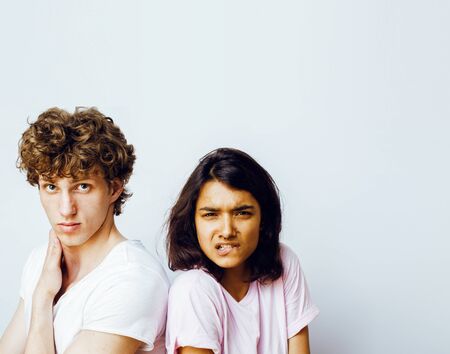 best friends teenage girl and boy together having fun, posing emotional on white background, couple happy smiling, lifestyle people concept, blond and brunette multi nations close upの写真素材