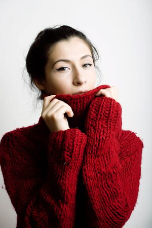 young pretty woman in sweater and scarf all over her face, lifestyle people winter conceptの写真素材
