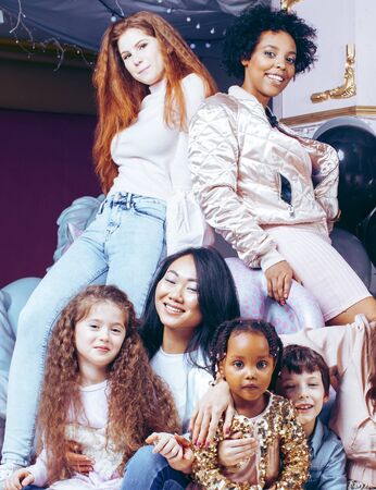 Lifestyle and people concept: young pretty diversity nations woman with different age children celebrating on birth day party together happy smiling, making selfie. African-american, asian and caucasianの写真素材