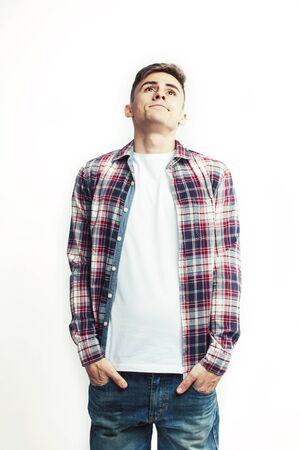 young handsome teenage hipster guy posing emotional, happy smiling against white background isolated, lifestyle people conceptの写真素材