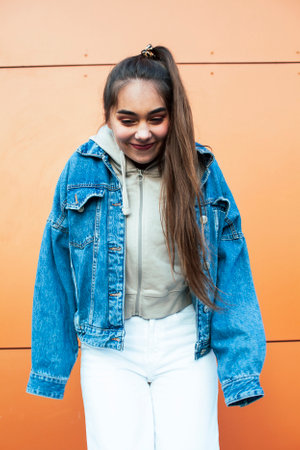 young pretty teenage girl posing cheerful happy smiling wearing street style outside in europe city, lifestyle people conceptの写真素材