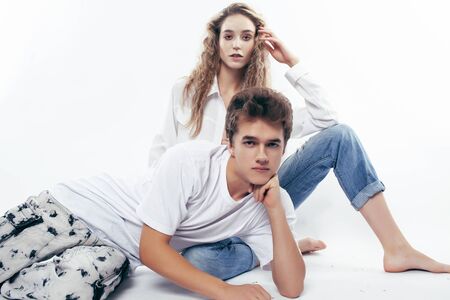 young pretty couple together posing cheerful isolated on white background, lifestyle people concept, happy boy and girlの写真素材