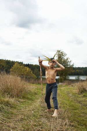 little cute boy playing outside like wild indian chief, lifestyle real people conceptの写真素材