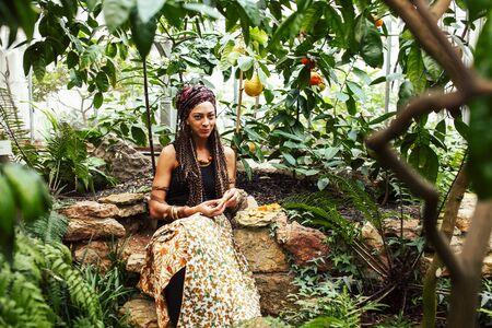 pretty islam woman in orange grove smiling, real muslim girl cheerful , nature organic people conceptの写真素材
