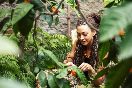 pretty islam woman in orange grove smiling, real muslim girl cheerful , nature organic people conceptの写真素材
