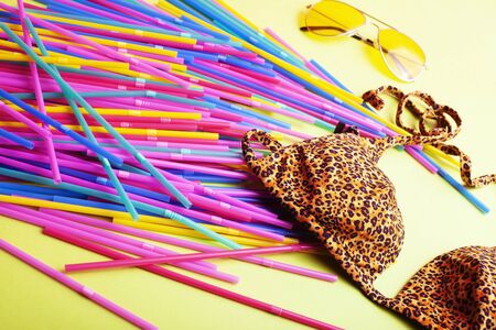 summer stuff on yellow background close up top view