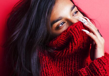 young pretty indian girl in red sweater posing emotional, fashion hipster teenage, lifestyle people...