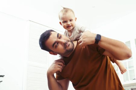 young real father with little cute son todler on kitchen in morning, lifestyle people concept