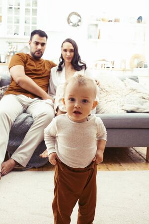 young family with little cute son on kitchen in morning happy smiling, lifestyle people concept