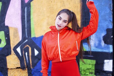 young pretty teenage girl doing sport outside on city background, lifestyle people conceptの写真素材