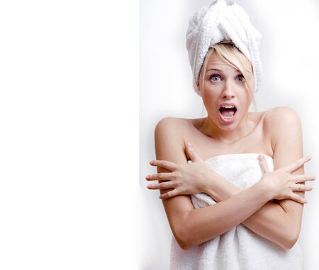 young pretty blond smiling woman with white towel on head posing cheerful on white background, lifestyle people conceptの写真素材