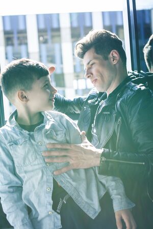 happy family together concept, father and son at window huggings, enjoying sunlight, lifestyle...