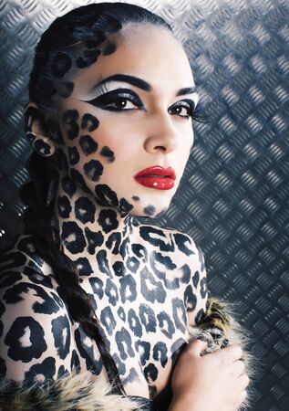 young sexy woman with leopard make up all over body, cat bodyart print closeupの写真素材