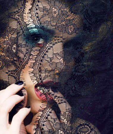 portrait of beauty young woman through lace close up mistery makeup sexy, fashion people concept