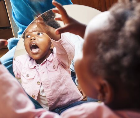 little cute african american girl playing with animal toys at home, pretty adorable princess in...
