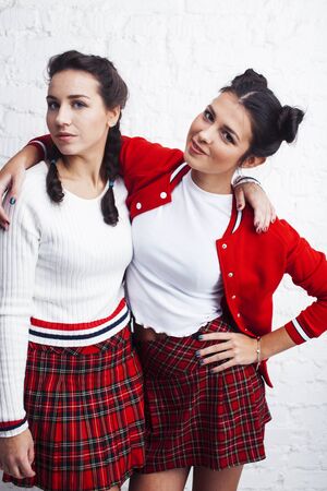 best friends teenage girls together having fun, posing emotional on white background, besties happy smiling, lifestyle people conceptの写真素材