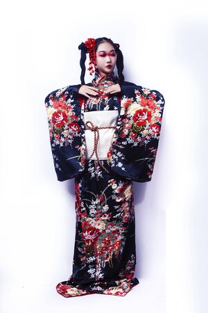 young pretty geisha in black kimono with sakura, asian ethno closeup on white background isolatedの写真素材