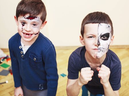 zombie apocalypse kids concept. Birthday party celebration facepaint on children dead bride, scar face, zombie skeleton together closeup makeup emotional posing.の写真素材