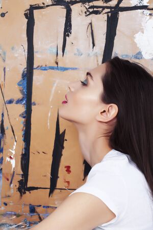 young brunette woman with fashion makeup on painted background, lifestyle people conceptの写真素材