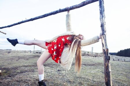 young pretty fashion style teenage girl posing cheerful at countryside background, lifestyle vacation people conceptの写真素材