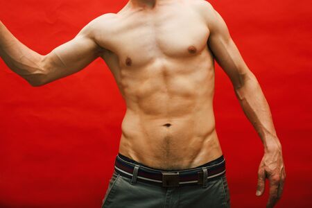 man standing naked torso abc on red background, lifestyle sport peopleの写真素材