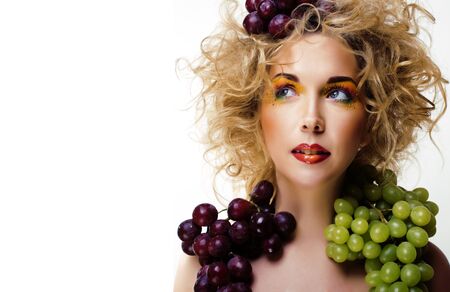 beautiful young woman portrait excited smile with fantasy art hair makeup style, fashion girl with creative food fruit orange, grapes, citrus make upの写真素材