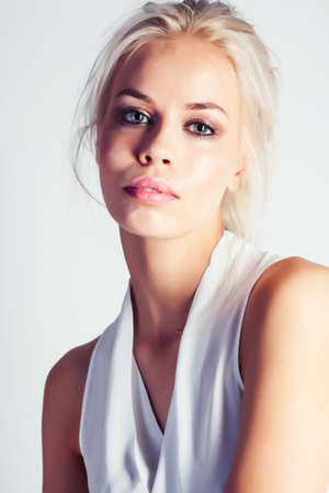 young pretty stylish hipster blond girl posing emotional isolated on white background happy smiling cool smile, lifestyle people conceptの写真素材