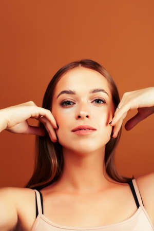 young pretty blond woman with fresh natural makeup posing cheerful on browm background, lifestyle people conceptの写真素材