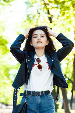pretty young asian woman smiling cheerful in green park on summer sunny day, lifestyle people...