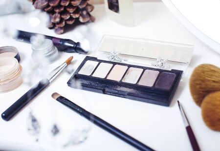 Jewelry table with lot of girl stuff on it, little mess in cosmetic brushes, women interior concept, perfume elegance things, little princess makeup closeupの写真素材