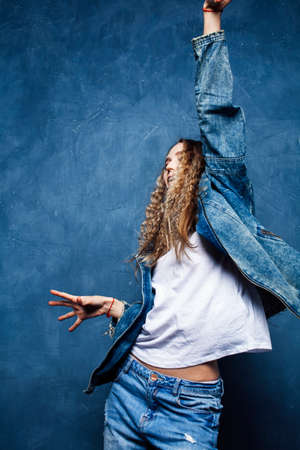 young pretty blond curly girl posing happy smiling on blue background, lifestyle people conceptの写真素材