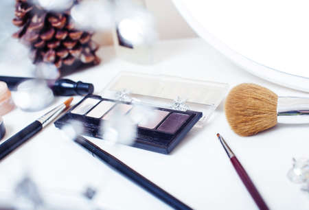 Jewelry table with lot of girl stuff on it, little mess in cosmetic brushes, women interior concept, perfume elegance things, little princess makeupの写真素材