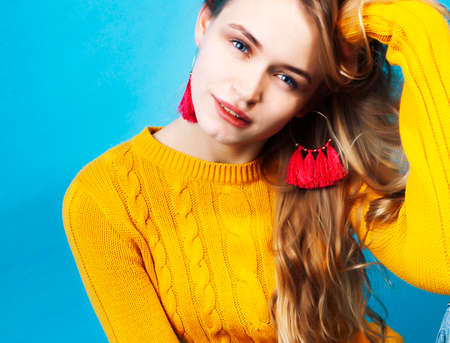 young pretty teenage modern hipster girl posing emotional happy on blue background, lifestyle people conceptの写真素材
