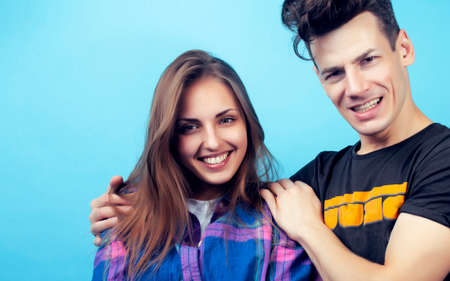 happy couple together posing cheerful on blue background , guy and girl students together friendsの写真素材
